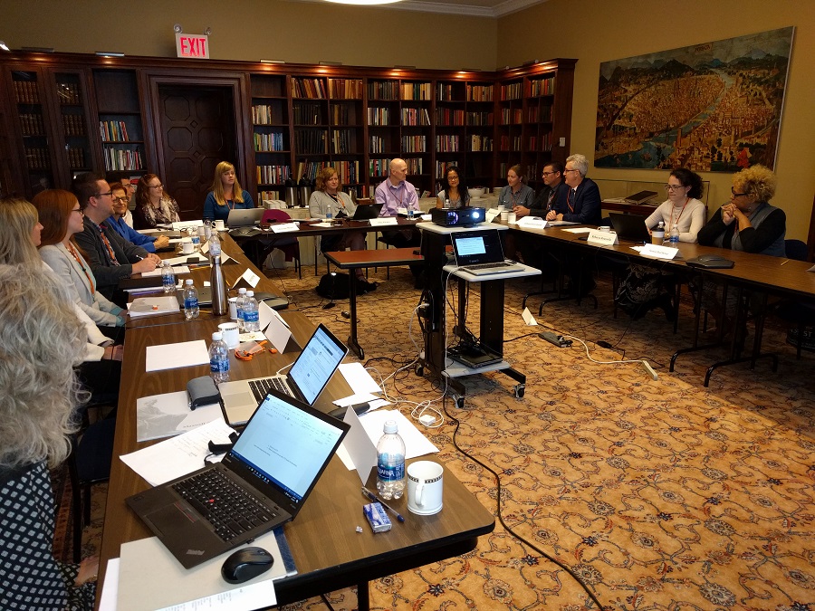 Workshop attendants participating intently in Syracuse University's Lubin House library in New York City.
